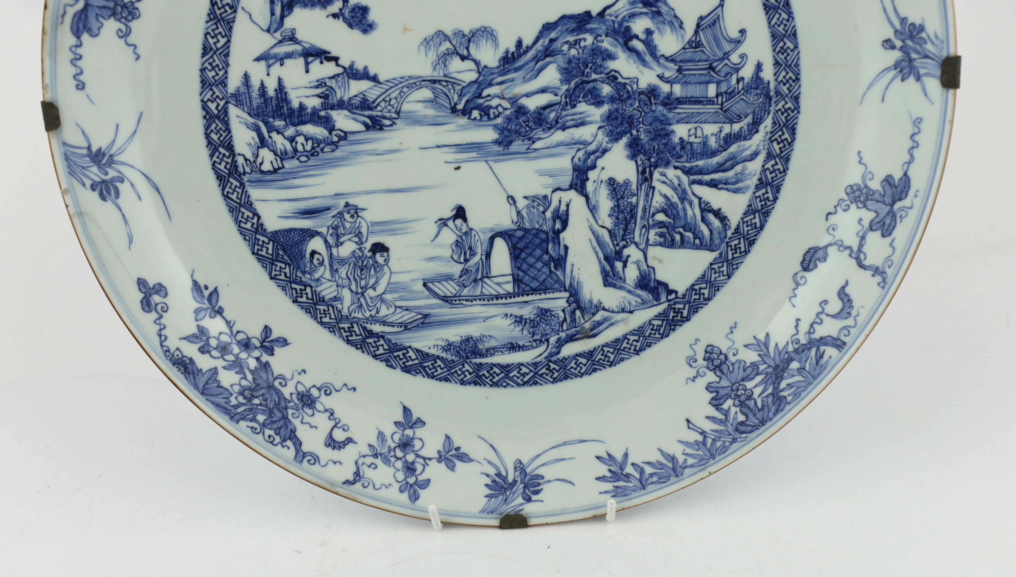 A Chinese blue and white landscape dish, Yongzheng/Qianlong period, short hairline crack